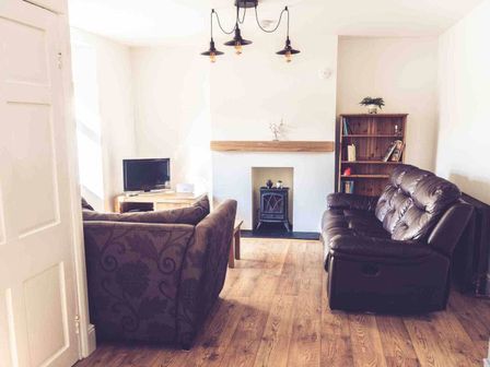 A living room with a sofa, coffee table, television and fireplace at 3Bed Cottage Plymouth Dog friendly Sleeps7 Plymouth