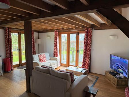 A living room with a sofa and television at Tremail near Camelford