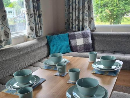 A dining area with plates and cups on a table at The Old Barn in Manchester
