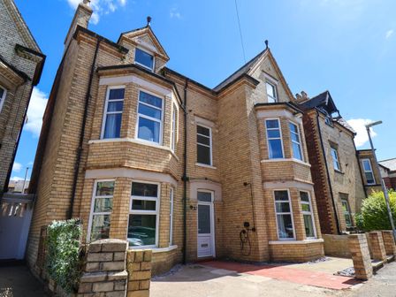 A house with a brick exterior and windows at Lansdowne Grange in Bridlington