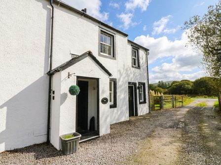 An exterior view of a house with a gravel pathway at Bramble near Cleator Moor