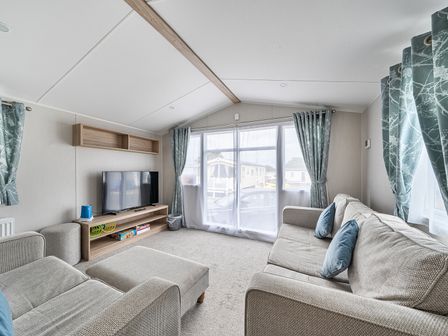 A living room with a sofa and television at Primrose Valley 3Bed Caravan Sleeps 8 Pets Ok in Primrose Valley