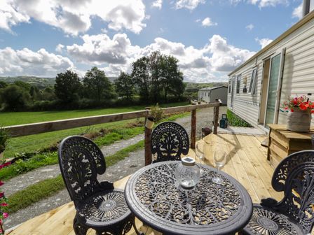 An outdoor seating area with a table and chairs at Leven in Lampeter