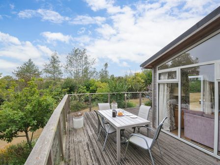An outdoor deck with a table and chairs at 5 Tree Tops in Dobwalls