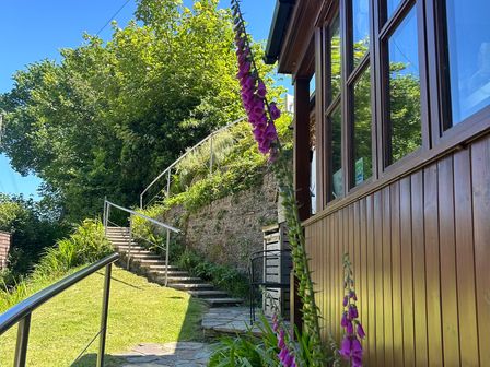 An outdoor area with stairs leading to a pathway at The Old Forge in Hallsands