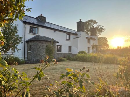 A house with a garden at sunset at