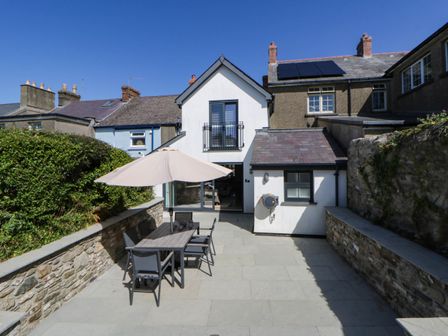 An outdoor patio with table and chairs at Rheidiol in St Davids