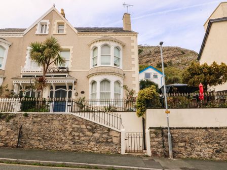 A house with windows and a garden at Tudno Lodge Llandudno