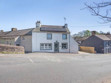 A house featuring solar panels and windows at The Quirky Cottage near Eamont Bridge