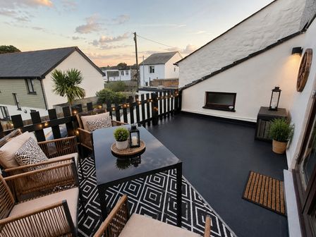 An outdoor terrace with seating and a table at Stylish Cornish Retreat, Sleeps 4 Near Hayle Beach in Hayle