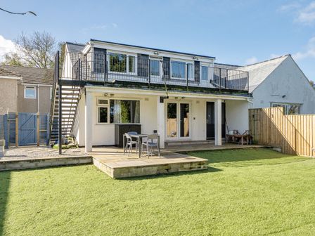 An outdoor area with a deck and seating at 2 Bedroom Apartment Sleeps 3 Garden Pets Carbis Bay