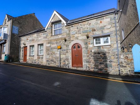 A stone cottage facade with doors and windows at 2 bed Criccieth