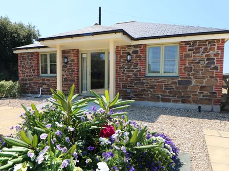 A house with a flower bed and pathway at Elm Cottage in Truro