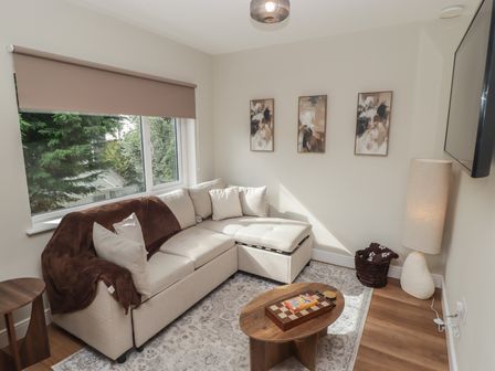 A living room with a sofa and coffee table at Flat 2 Tenby