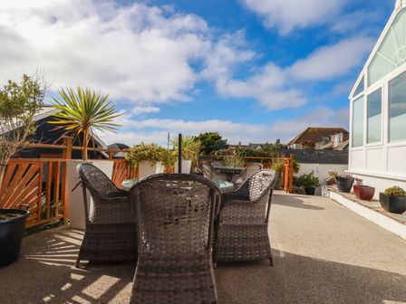 An outdoor patio with a table and chairs at Apartment 1 in Newquay