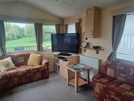 A living room with a TV and sofas at Chapel Farm Holiday Park No 6 Bunnies View in Appleby-in-Westmorland