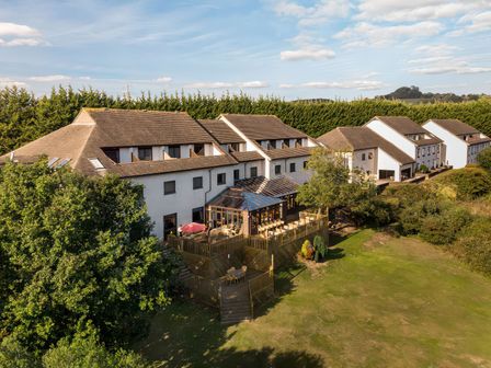 An outdoor area with decking and buildings at Willow in Kingsteignton