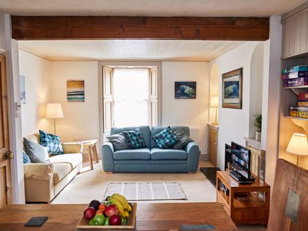 A living room with a sofa, lamp, and television at The Old Barn in Manchester