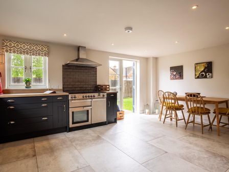 A kitchen with stove and dining area at the property in location