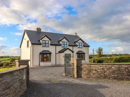A house with a gate and driveway at Wild Atlantic Ferry View, Kilrush, County Clare
