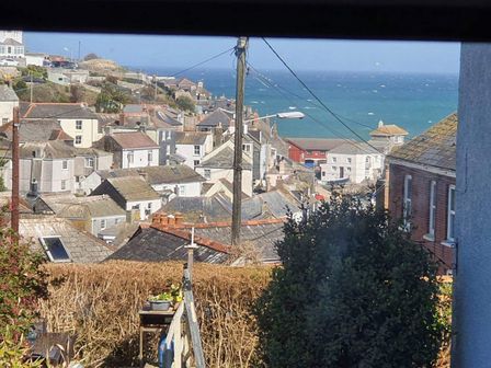 A view of a coastal town with houses and sea at 1 Bedroom Apartment with Sea View Mevagissey