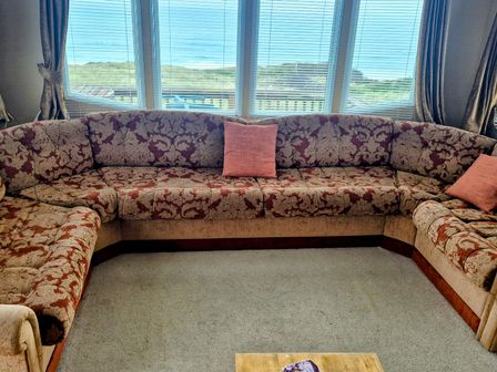 A living room with a sectional sofa and a coffee table at Haven Perransands, 575 Perranporth