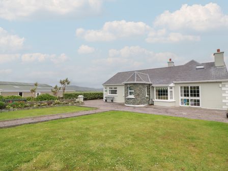 A house with a garden and pathway at Wild Atlantic Way Country Cottage in Portmagee, County Kerry