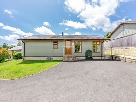 A single-story house with a tiled roof lawn and paved driveway at Lavender Lodge in Charlton Horethorne near Sherborne