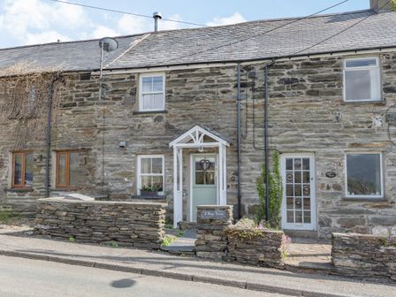 Stone cottage with slate roof two doors and stone walls at 2 Bryn Tirion in Llan Ffestiniog