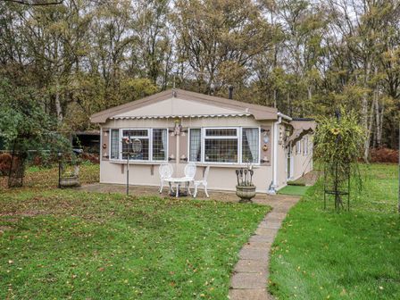 A cottage with a pathway and garden at The Lodge Old Buckenham near Attleborough