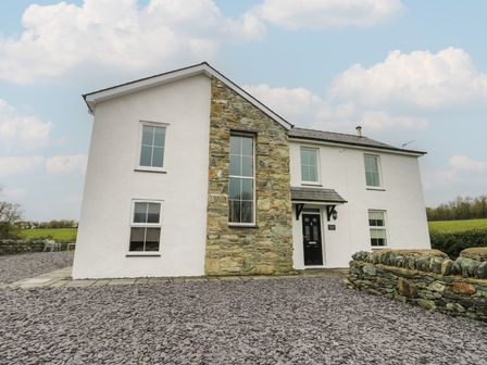 A house with stone wall and windows at Chapel House in Elim near Llanddeusant