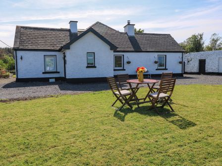 A house with a table and chairs in front at Ballaghboy Cottage, Boyle, County Sligo