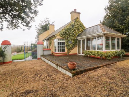 A single story house with a patio and garden gate at The Granary in Tallow near Lismore County Waterford