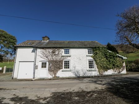 An exterior view of a house with ivy on the wall at Penlone Cottage Rhayader