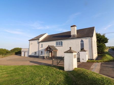 A house with a gate and driveway at Old Chapel in Clovelly