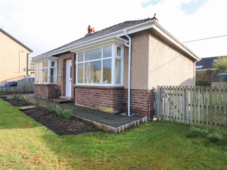 A single-story house with brick and pebble dash exterior and a front garden at Eusebank in Pooley Bridge