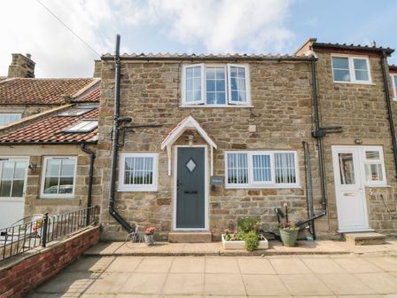 A stone house with a front door and windows at Fairhaven Cottage Ugthorpe near Runswick Bay