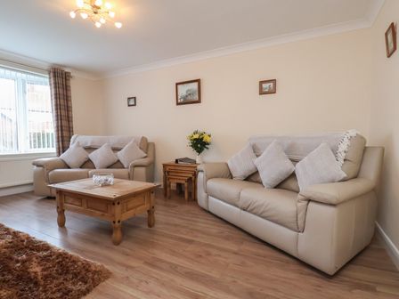 A living room with two sofas and a coffee table at La Rochelle in Whitby