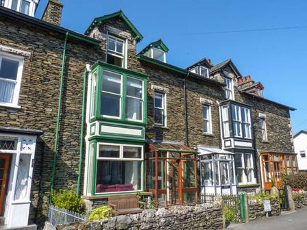 Stone terrace houses with bay windows and small front gardens at Parkgate in Windermere