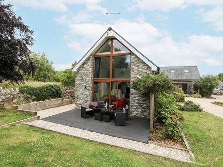 A house with outdoor seating area at Budmouth Upwey near Weymouth