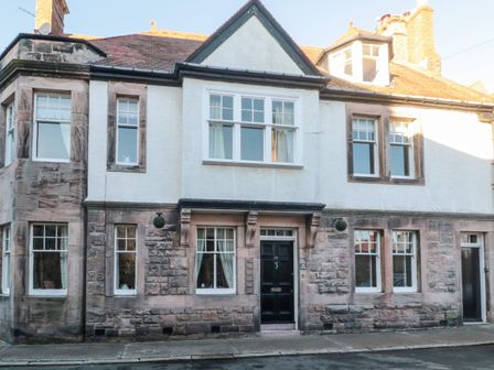 The front exterior of a two-story stone and stucco house with multiple windows and a black front door at Iona 10 Palace Street East in Berwick-upon-Tweed