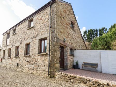 A stone house with windows and a front door at Kingfisher Barn East Taphouse