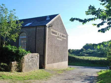 Exterior view of a building with a sign reading Thorne C M Chapel 1834 1947 surrounded by greenery at Thorne Chapel in Pembroke
