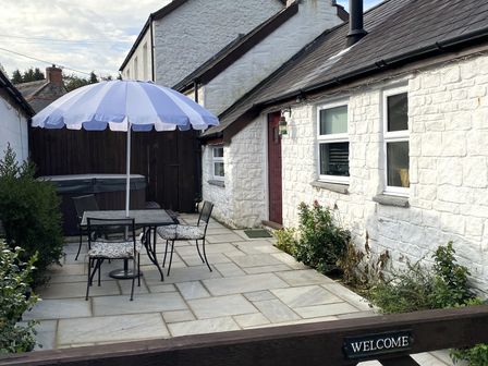An outdoor sitting area with a table and chairs at The Barn at Waunlippa Narberth