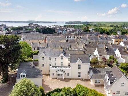 A coastal town with multiple houses and buildings near the sea at Hideaway House at The Hideaway in Tenby