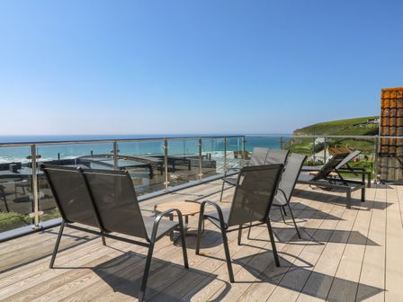 A balcony with chairs and a sea view at Trelawns in Mawgan Porth