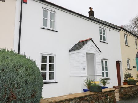 A row of terraced houses with white and cream walls and a small porch at Speedwell in Charlestown