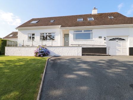 A house with a garage and garden at Bay View in Benllech