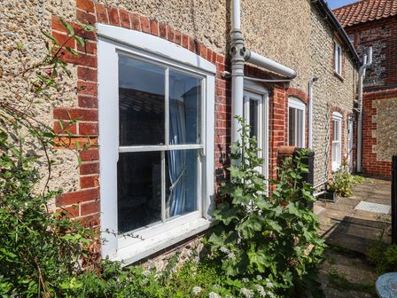 An outdoor area showing a window and plants at Delphinium in Blakeney, Norfolk
