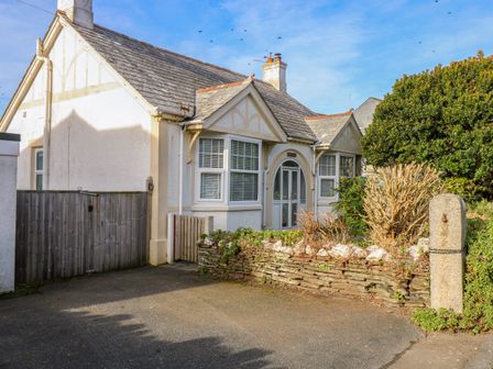 The front of a single-story house with a paved driveway and a small garden at Pound Rocks in Tintagel